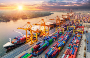 goods for export being loaded on ships at port