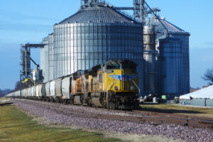 train leaving grain elevator trade with Mexico and Canada